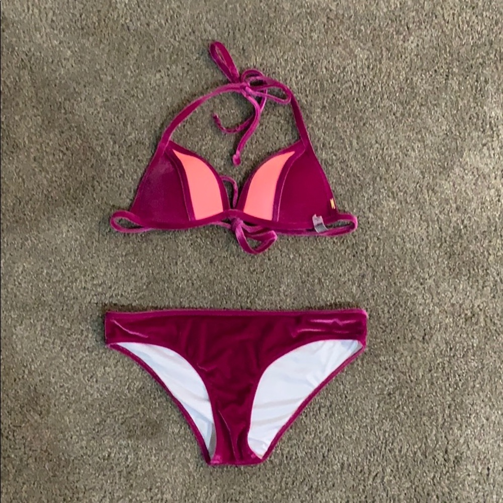 This is a magenta Victoria’s Secret swimsuit